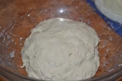 Рецепт - ХАЧАПУРИ ПО-МЕГРЕЛЬСКИ - Шаг 4 -  Продолжайте замешивать тесто. Если оно получается жидковатым и липким, добавьте муки столько сколько нужно, чтобы добиться желаемой консистенции. Тесто на хачапури должно быть упругим, мягким, гладким, пластичным и не липнущим к рукам. Накройте миску с тестом кухонным полотенцем. Поставьте в теплое место без сквозняков на расстойку. Оставьте на 1,5 часа.